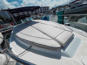 A cozy lounge area on a boat featuring plush seating, perfect for relaxing while enjoying the water views.