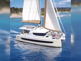 A stunning catamaran sails through crystal-clear waters, featuring guests enjoying the journey — perfect for sailing adventures and tropical getaways.