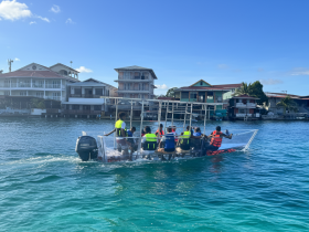 A group of people enjoying a boat ride in clear waters, showcasing the vibrant local scenery and the thrill of on-water activities.