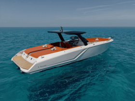 A sleek speedboat glides through crystal-clear waters, showcasing its modern design and vibrant orange accents — perfect for thrilling adventures on the open sea.