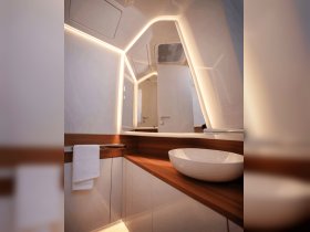A sleek and modern bathroom interior on a boat, featuring elegant lighting and a stylish sink, perfect for luxury cruising experiences.