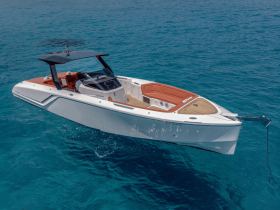 A stunning aerial view of a sleek speedboat gliding through crystal-clear waters, perfect for thrilling adventures on the open sea.