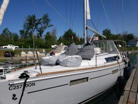 A sleek yacht docked at the marina, showcasing its elegant design and spacious deck, perfect for leisurely outings on the water.