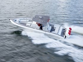 A sleek speedboat in motion, showcasing its impressive design and performance on the water — perfect for thrilling adventures and water sports.