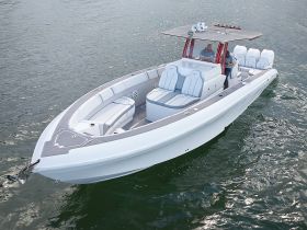 A sleek speedboat cruising through the water, showcasing its modern design and spacious seating — perfect for thrilling adventures on the open sea.