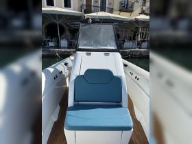 Interior view of a boat's helm seating area, showcasing comfortable blue cushions and a sleek design, perfect for navigating the waters in style.