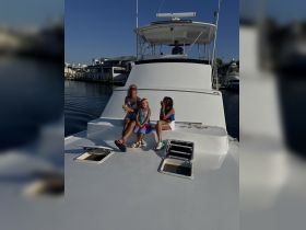 A family enjoys a sunny day on a boat, capturing joyful moments together — perfect for creating lasting memories on the water.