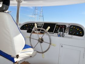 A well-equipped helm area showcasing the steering wheel and control console of a boat, perfect for navigating the open waters.