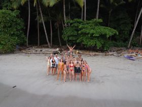 A lively group of friends gathers on the beach, enjoying a fun day in the sun — perfect for celebrations and memorable outings.