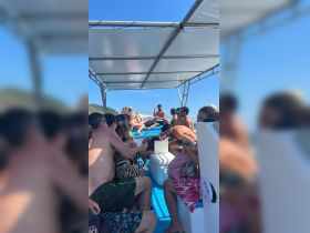 A lively group enjoys a fun day on the boat, showcasing the perfect atmosphere for celebrations and social gatherings on the water.