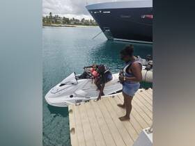 A family enjoys a fun moment on a jet ski, with a child safely seated and ready for an exciting water adventure. Perfect for creating unforgettable memories on the water.