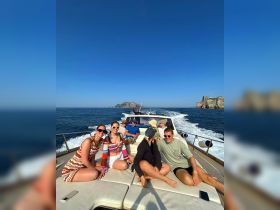 A lively group enjoys a sunny day on a boat, capturing the essence of fun and adventure on the open water.