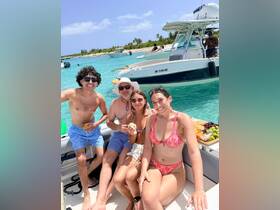 A cheerful group enjoys a fun day on the water, sharing snacks and drinks aboard a boat, perfect for summer outings and celebrations.