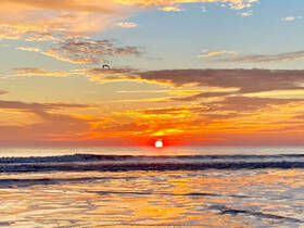 A breathtaking sunset over the ocean, casting vibrant colors across the sky and reflecting on the water — a perfect backdrop for evening boat trips or beach relaxation.