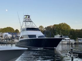 A sleek yacht navigates through the marina, showcasing its impressive design and the excitement of being on the water.