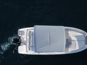 Aerial view of a sleek speedboat gliding through deep blue waters, showcasing its stylish design and spacious seating — perfect for thrilling adventures on the water.