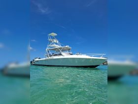 A sleek speedboat glides through clear turquoise waters, showcasing its impressive design and perfect for thrilling adventures on the sea.