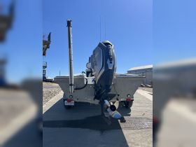 A clear view of the back of a boat featuring an outboard motor, showcasing its sleek design and functionality — perfect for fishing or recreational boating.