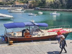 A vibrant scene at the dock with a boat and people enjoying the waterfront — perfect for exploring local attractions and leisure activities.