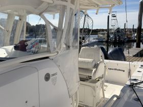 An interior view of a sportfishing boat's helm area, showcasing the seating and console, perfect for a day out on the water.