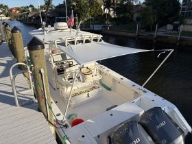 An interior view of a well-equipped boat helm featuring a console and seating area, perfect for navigating the waterways in comfort.