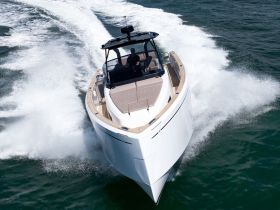 A stunning aerial view of a sleek speedboat cutting through the waves, showcasing its elegant design and powerful performance on the water.
