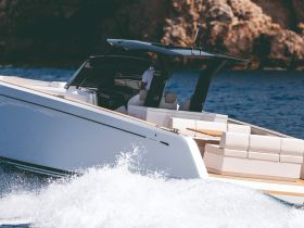 A sleek speedboat cuts through the waves, showcasing its modern design and spacious seating — perfect for thrilling water adventures.