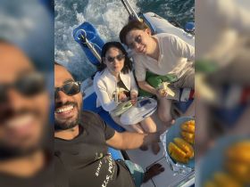 A cheerful group enjoys snacks aboard a boat, capturing a fun moment on the water. Perfect for showcasing memorable boating experiences.