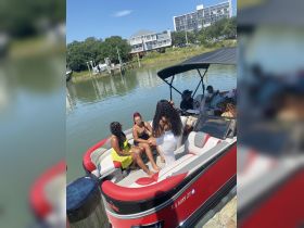 A lively group enjoys their time aboard a boat, showcasing a fun and festive atmosphere perfect for summer celebrations.