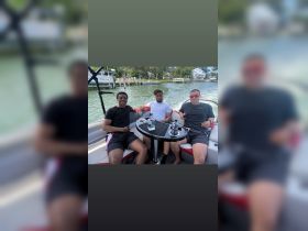 A group of friends enjoys a relaxing day on the water, sharing drinks and laughter aboard a boat — perfect for summer outings and memorable adventures.