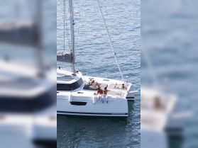 A group of friends enjoys a relaxing day on a catamaran, soaking up the sun and creating unforgettable memories on the water.