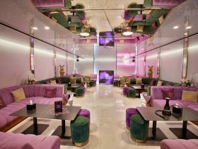Luxurious lounge area inside a boat featuring plush seating and elegant decor, perfect for relaxing and socializing while on the water.
