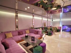 Stylish interior lounge area of a boat featuring plush seating and modern decor, perfect for relaxing and socializing on the water.