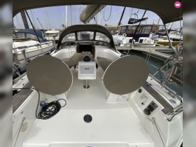Interior view of a yacht's helm area, showcasing comfortable seating and navigation equipment, perfect for relaxing while sailing.