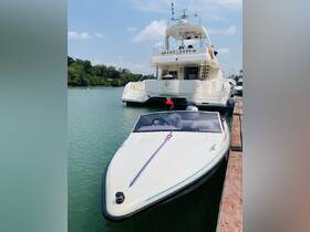 A sleek speedboat docked alongside a larger yacht, showcasing the vibrant design and tranquil waters of the marina.