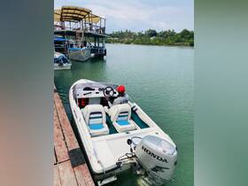 A view of the interior of a small boat, showcasing the helm and seating area, perfect for leisurely outings on the water.