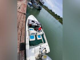 A view of the interior of a boat featuring comfortable seating and a helm, with a person preparing for the next adventure on the water.