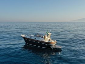 Aerial view of a stylish boat cruising through calm waters, showcasing its elegant design and perfect for leisurely outings.