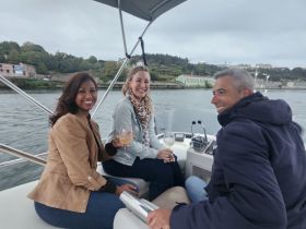 A cheerful group enjoys cocktails aboard a boat, capturing the essence of a fun and relaxing outing on the water.
