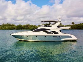 A stunning side view of a luxury yacht docked in serene waters, surrounded by lush greenery — perfect for upscale boating adventures.