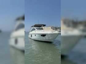 A sleek yacht docked in calm waters, showcasing its elegant design and inviting atmosphere for leisure cruising.