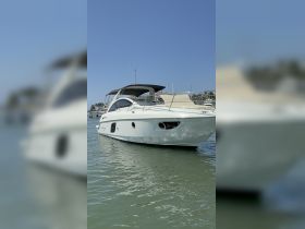 A sleek yacht captured from the front, showcasing its elegant design while floating in calm waters — perfect for luxury outings or private charters.