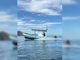 A speedboat named 'One More 10095' glides through clear waters, showcasing its sleek design and fishing gear, perfect for adventurous outings.