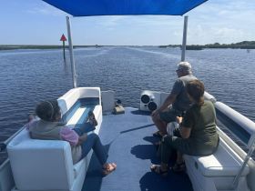 A group enjoys a relaxing day on a boat, taking in the scenic waterways — perfect for leisurely outings and nature exploration.