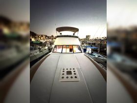 A stunning view of a yacht's bow at dusk, showcasing its sleek design and the marina ambiance, perfect for evening cruises.