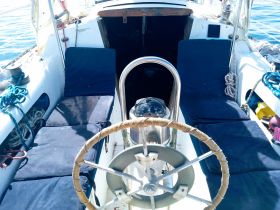 A well-equipped helm area of a boat featuring comfortable seating and navigational instruments, perfect for a day on the water.