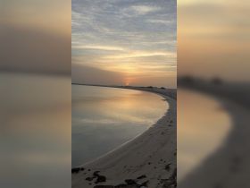 A serene sunset view over calm waters, capturing the tranquil beauty of nature. Ideal for relaxation and scenic photography.