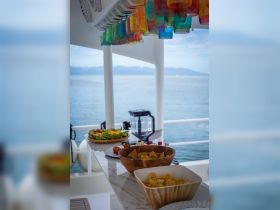 A beautifully arranged spread of snacks and drinks on a boat's bar, perfect for enjoying a day on the water.