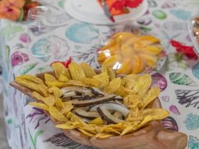 A beautifully arranged platter of snacks featuring plantain chips and other treats, perfect for onboard catering during a boat trip.
