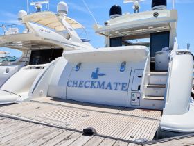 A detailed view of the back of the luxurious yacht 'CHECKMATE', showcasing its elegant design and features, perfect for upscale boating experiences.
